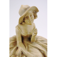 Een terracotta sculptuur van een dame met hond